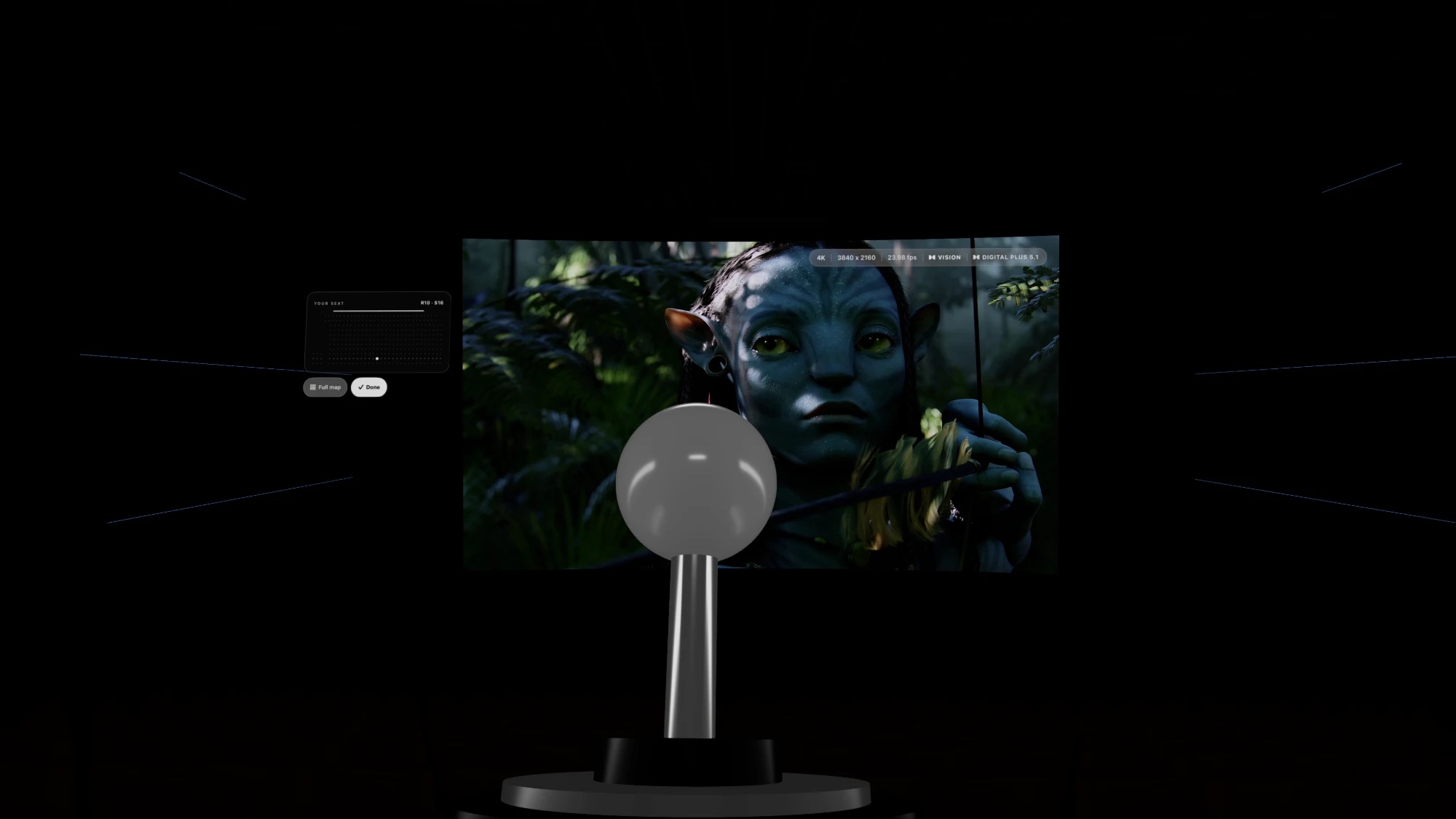 The seat joystick in Shibuya Theater, in front of a curved screen playing Avatar, with a small card showing your seat on the map